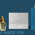 Variety of Swaas fragrance bottles lined up on a wooden shelf.