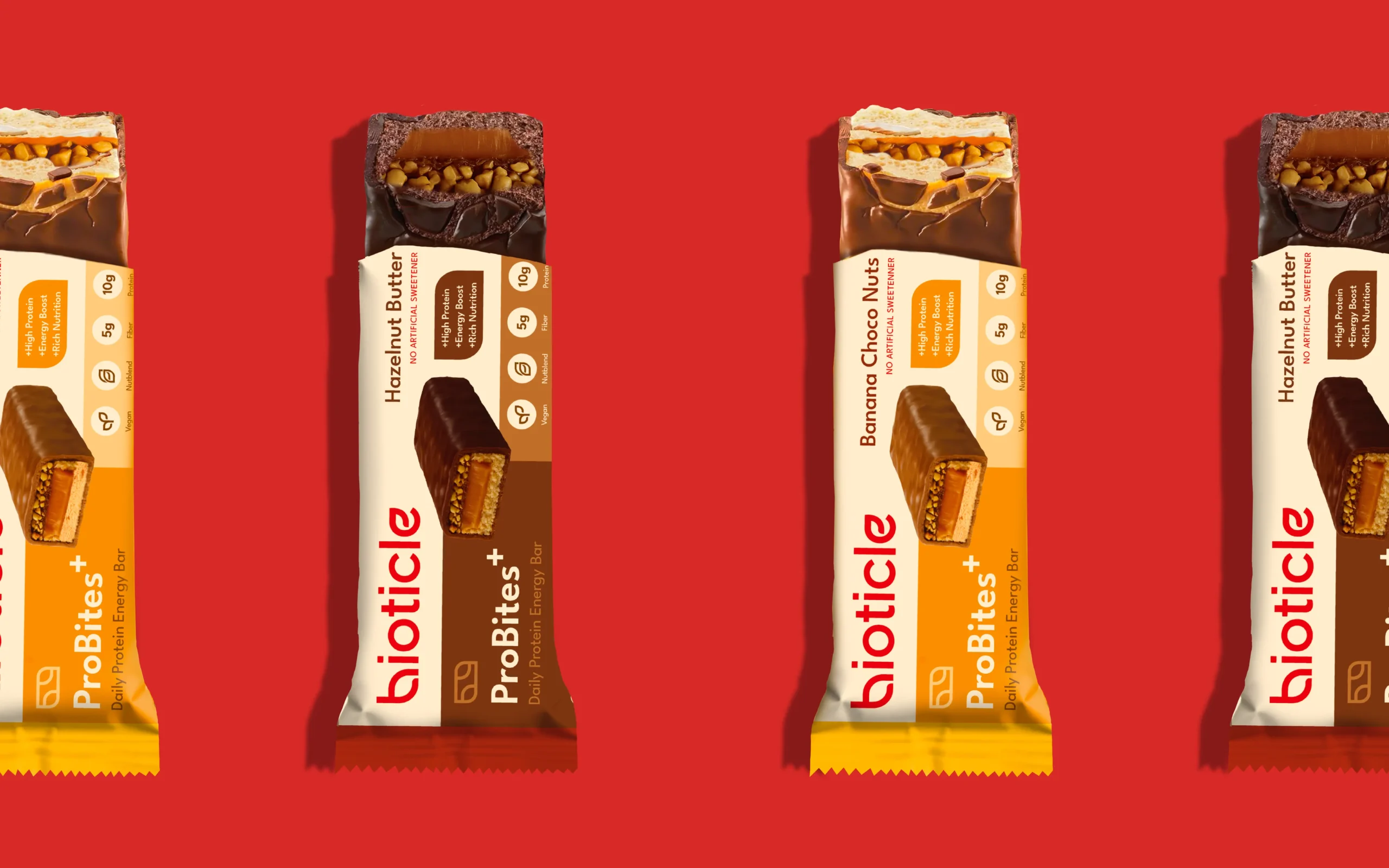 ProBites+ protein bars partially unwrapped on red background, flavor variants with rich fillings, premium snack branding and packaging design.