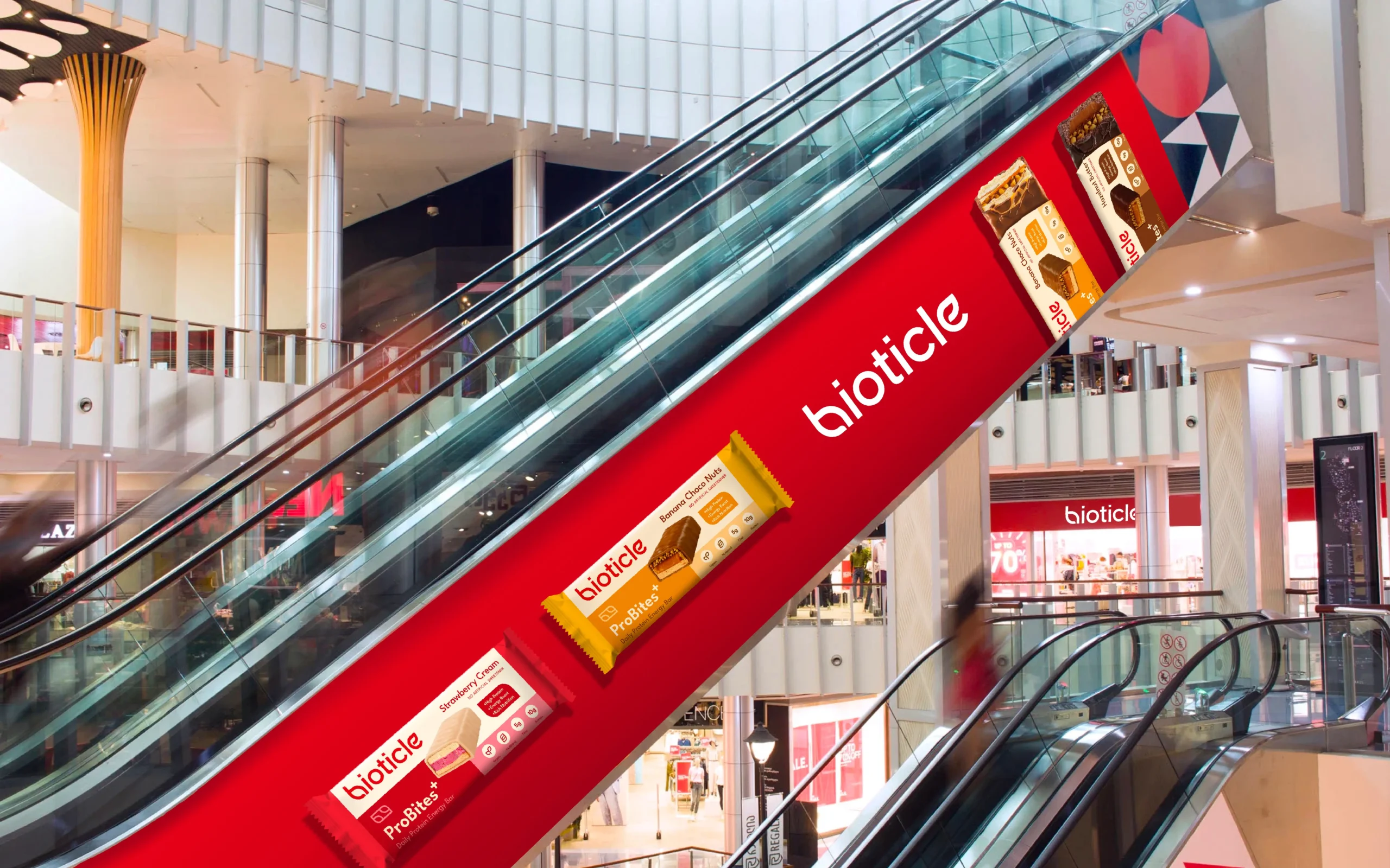 Shopping mall escalator wrap - Bioticle ProBites+ protein bars OOH advertising - packaging and branding showcase