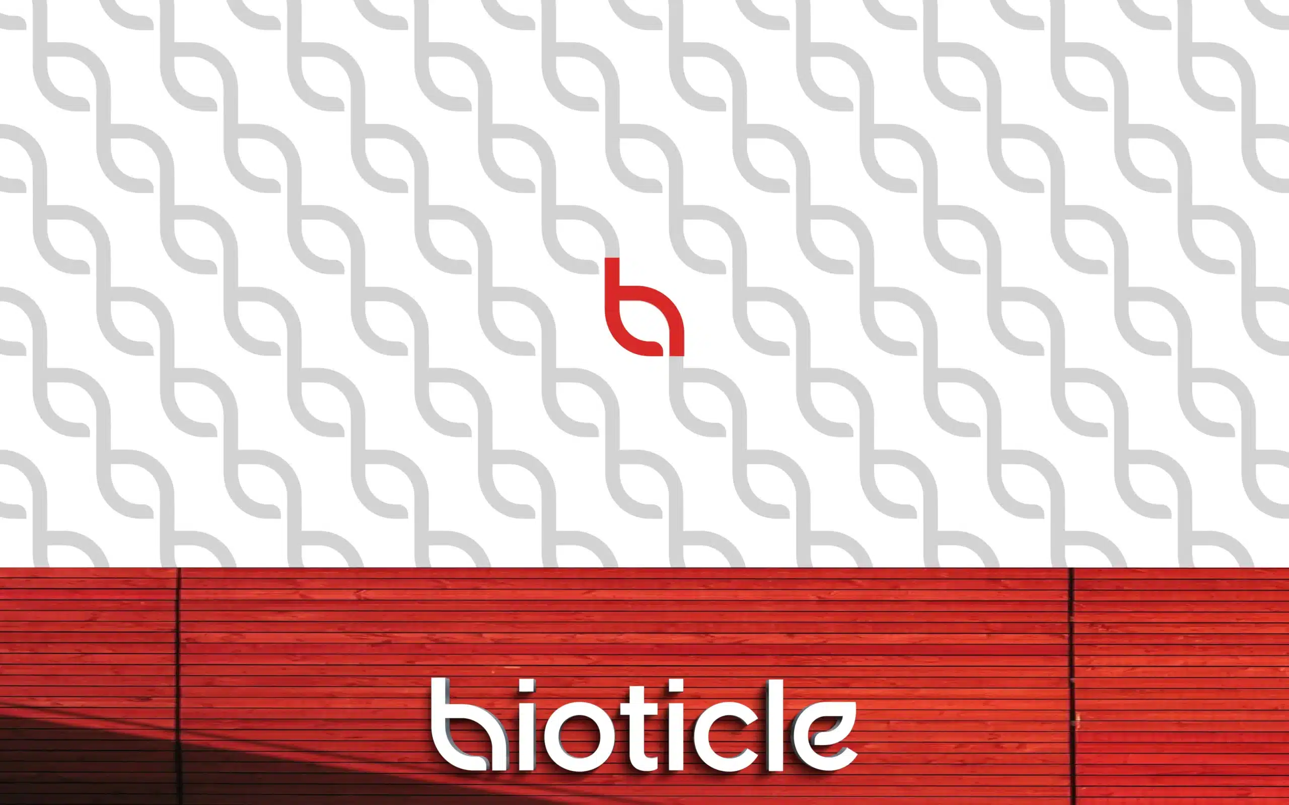 Bioticle repeating leaf monogram pattern with exterior signage on red cladding, pattern design for brand assets, retail and packaging applications.